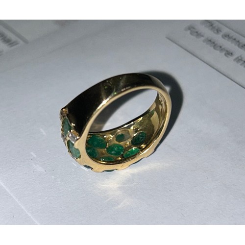 140 - An 18ct yellow gold dress ring, channel set with 13 x emeralds and 14 diamonds in a chequered design... 