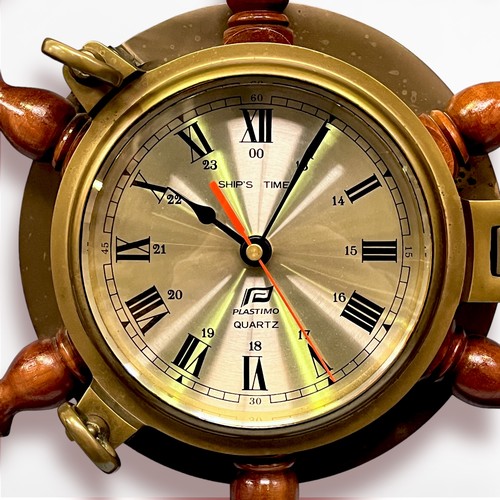 558 - A 20th century Plastimo 'Ship's Time' quartz wall clock, in brass bulkhead case, mounted on a wooden... 