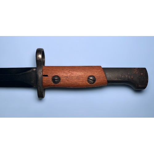 561 - A Belgian SA30 bayonet with 225mm double-edged blacked steel blade, wooden grips and black metal sca... 