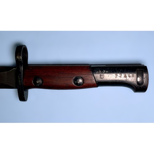 561 - A Belgian SA30 bayonet with 225mm double-edged blacked steel blade, wooden grips and black metal sca... 