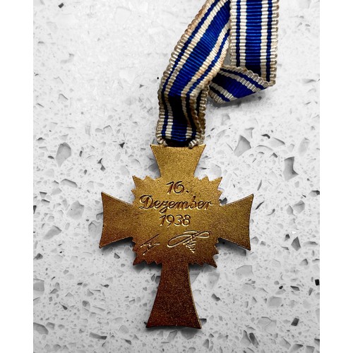 565 - A German Third Reich 'Cross of Honour of The German Mother' First Class badge, gilt bronze and ename... 