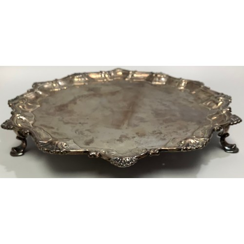 70 - A small George III silver salver by Richard Rugg I, with srpentine and shell border, bull crest to c... 