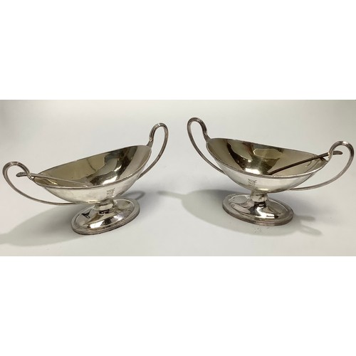 74 - A matched pair of Victorian silver salts by William Hutton & Sons, of oval/trophy form with with twi... 