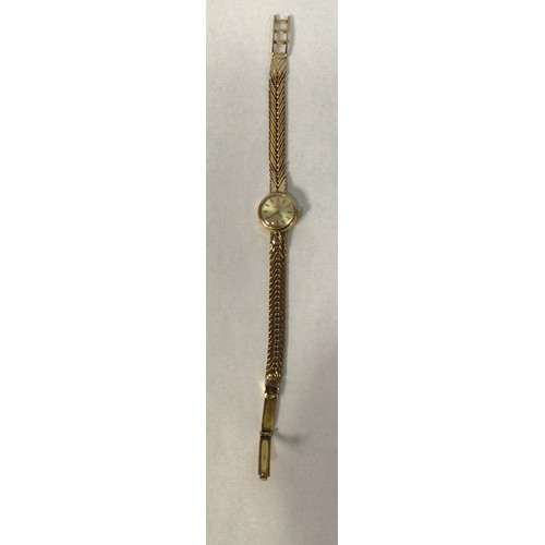 113 - A ladies 9ct gold Omega wristwatch, the circular silvered dial with applied gold batons denoting hou... 