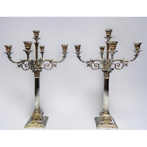 93 - A pair of silver-plated five light candelabra by Elkington & Co, each with scrolling, floral branche... 