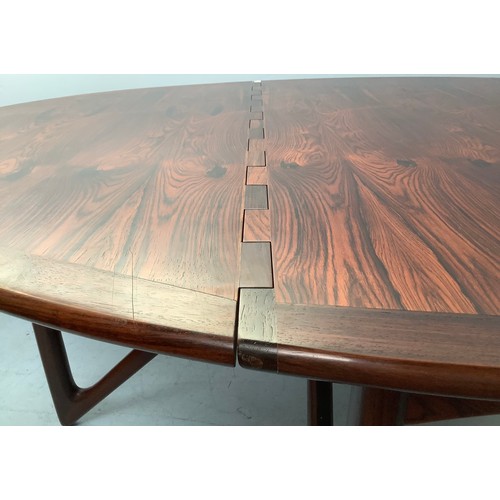 423 - A mid-century rosewood oval drop leaf dining table, the top with square sectioned piano hinges to ea... 