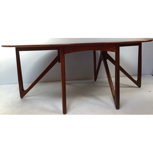 423 - A mid-century rosewood oval drop leaf dining table, the top with square sectioned piano hinges to ea... 