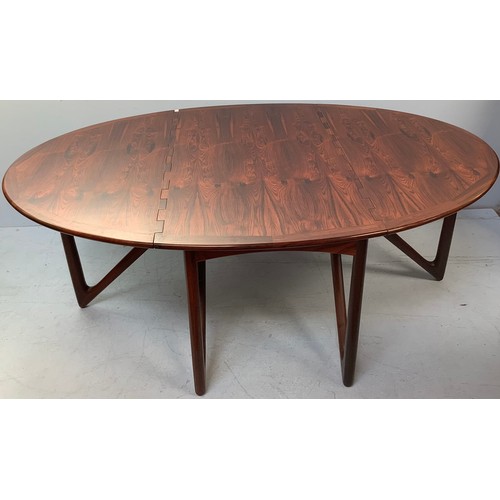 423 - A mid-century rosewood oval drop leaf dining table, the top with square sectioned piano hinges to ea... 