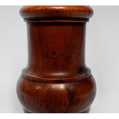 311 - An antique treen caster, yew or fruitwood, of baluster form, with rotating grinder, raised on turned... 