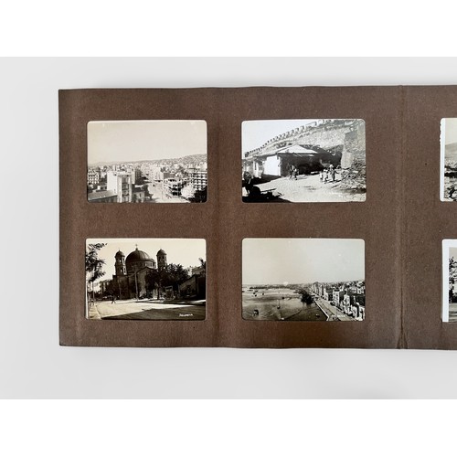 625 - A small photo album containing more than one-hundred and forty 78mm x 52mm monochrome topographical ... 