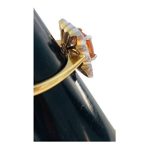 189 - An 18ct yellow gold tangerine spessartite garnet and diamond cluster ring, claw set with a central s... 