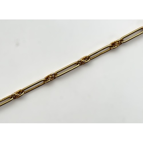 196 - An 18ct gold Figaro style Albert chain with alternating elongated links and knot links, with t-bar a... 