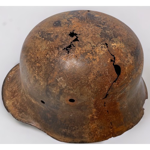 588 - A WW1 Imperial German M16 Helmet, 1916-1917 (Italian Front), generally as found, rusted through in p... 