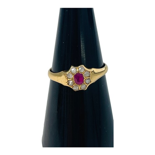 203 - An 18ct yellow gold dress ring, set with a central red oval stone, surrounded by 8 x small white sto... 