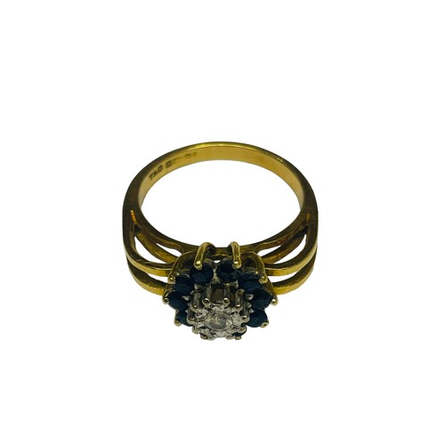 233 - An 18ct yellow gold dress ring, centrally claw set with a small round brilliant cut diamond, surroun... 