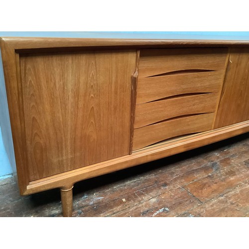 424 - A 1960’s Danish teak sideboard by Axel Christensen for ACO Møbler Danish Mobler, with three sliding ... 