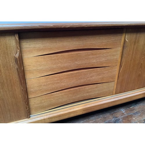 424 - A 1960’s Danish teak sideboard by Axel Christensen for ACO Møbler Danish Mobler, with three sliding ... 