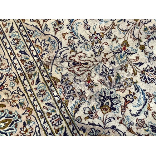 407 - A Persian hand-knotted wool Nain carpet, with central medallion to an ivory ground, worked with styl... 