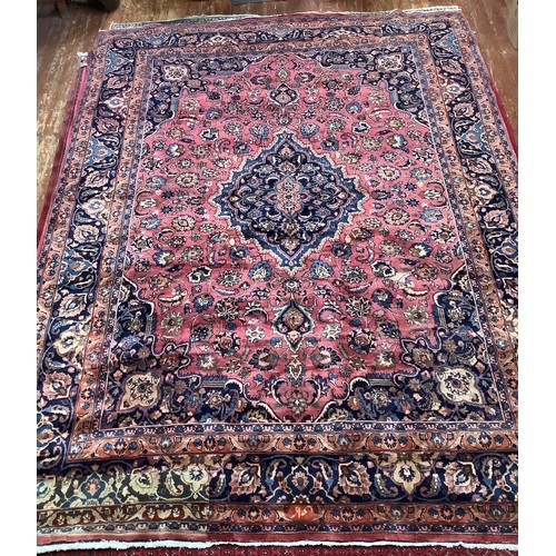 410 - A Persian hand-knotted wool Kashan carpet, with stylised central medallion to a deep red ground, blu... 