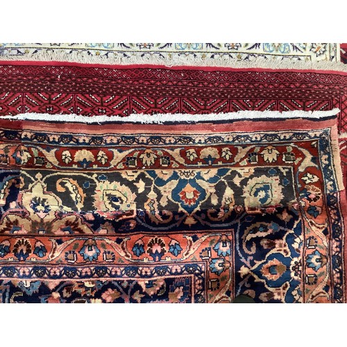 410 - A Persian hand-knotted wool Kashan carpet, with stylised central medallion to a deep red ground, blu... 