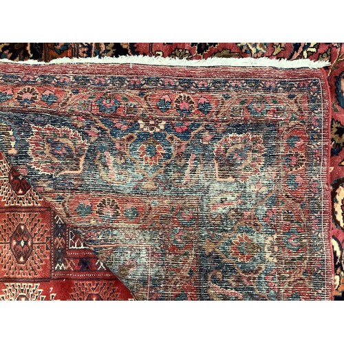 410 - A Persian hand-knotted wool Kashan carpet, with stylised central medallion to a deep red ground, blu... 