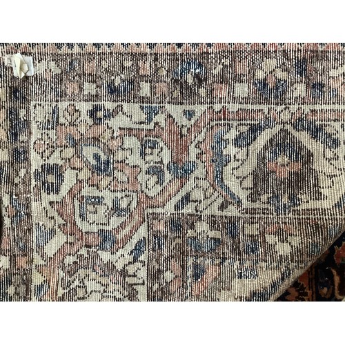 411 - A Persian Bakhtiar carpet, with stylised blue and red central medallion and blue spandrels, cream ou... 