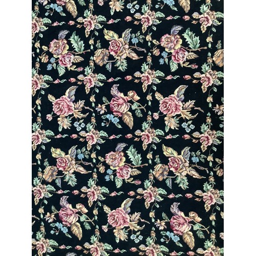 414 - A hand-knotted fatweave floral carpet, worked with a field of roses and trellis to a black ground wi... 