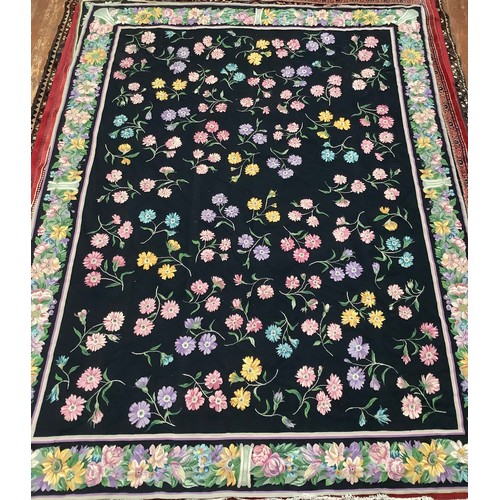 415 - A hand-knotted flatweave carpet, worked with an all-over field of scattered flowers to a black groun... 