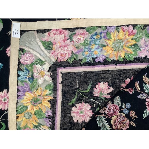 415 - A hand-knotted flatweave carpet, worked with an all-over field of scattered flowers to a black groun... 