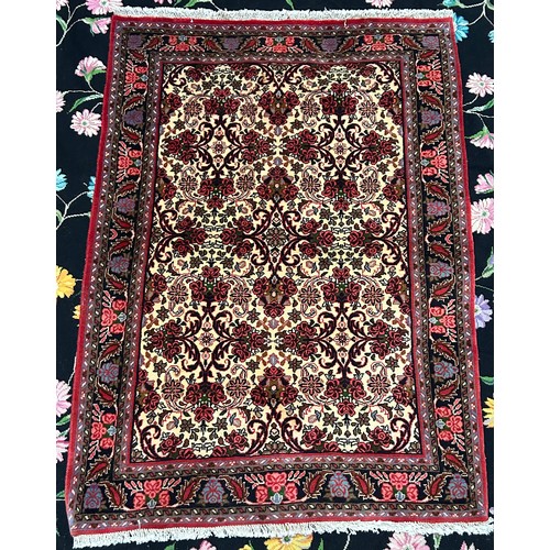 416 - A hand-knotted oriental rug, worked with a field of herati to a biege ground with a stylised Shah Ab... 