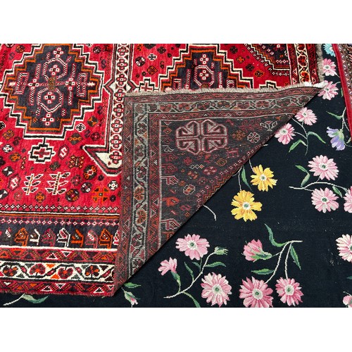 417 - A hand-knotted oriental rug of Ashfar style, worked with three central guls to a red ground within f... 