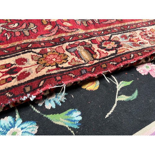 418 - A Persian hand-knotted wool rug, worked with a central stylised floral medallion to a red ground, wi... 