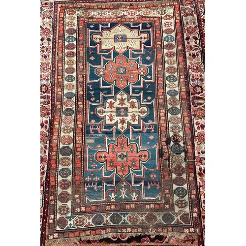 419 - A hand-knotted tribal wool rug of Afshar design, worked with three guls to a blue ground within a be... 