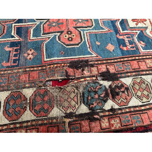 419 - A hand-knotted tribal wool rug of Afshar design, worked with three guls to a blue ground within a be... 