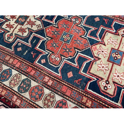 419 - A hand-knotted tribal wool rug of Afshar design, worked with three guls to a blue ground within a be... 