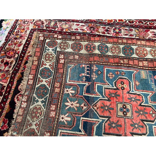 419 - A hand-knotted tribal wool rug of Afshar design, worked with three guls to a blue ground within a be... 