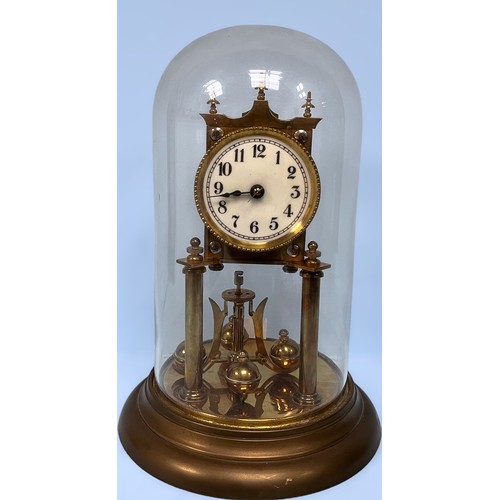 380 - An early 20th Century brass anniversary clock raised on two pillars with glass dome (af), together w... 