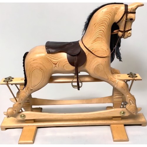 368 - A hand-made, unpainted wooden rocking horse, lacquered with exposed grain, brown leather and brass f... 