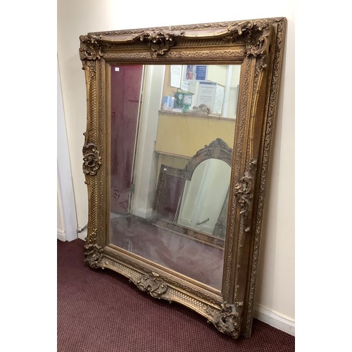 421 - A large ornate gilt framed mirror, overall size 130cm x 160cm