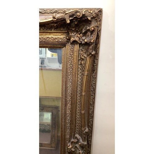 421 - A large ornate gilt framed mirror, overall size 130cm x 160cm