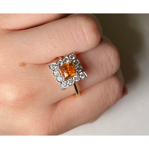 189 - An 18ct yellow gold tangerine spessartite garnet and diamond cluster ring, claw set with a central s... 