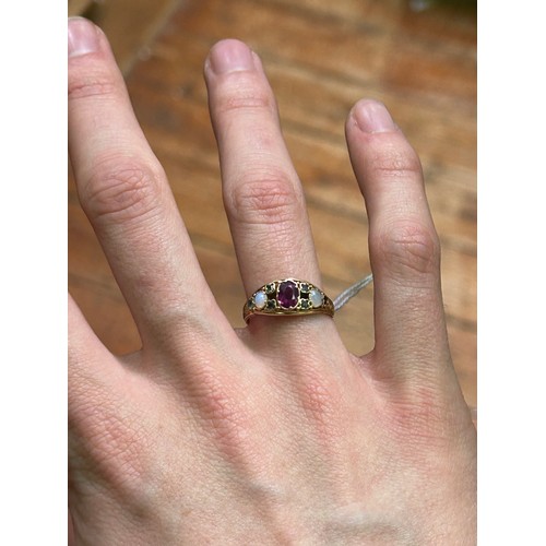 212 - A 15ct yellow gold dress ring, set with a central amethyst, with tourmaline and opals either side (S... 