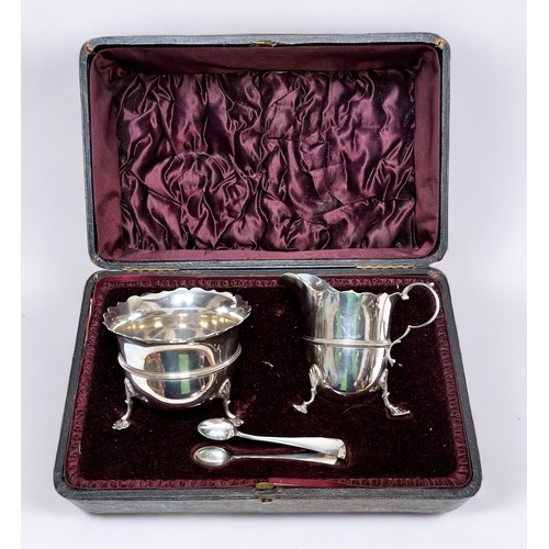 68 - A late Victorian silver cream jug and sugar bowl with tongs, serpentine cut rims on scrolled Anthemi... 