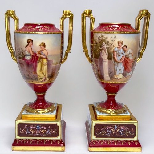 2 - WITHDRAWN: A pair of 19th century Vienna Porcelain twin-handled pedestal vases, rouge grounds gilded... 