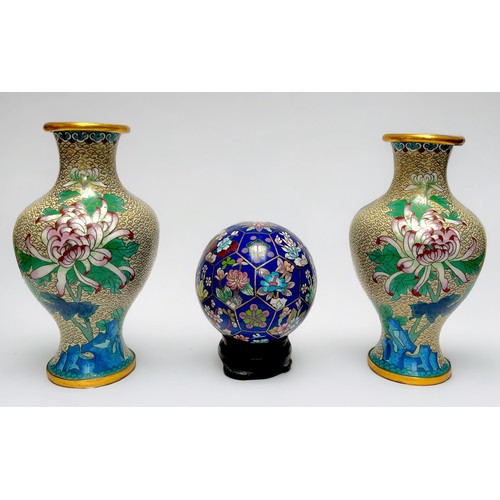 57 - A pair of Chinese Cloisonne enamel vases with flowers to a cream cloud-scroll ground, 25cm together ... 