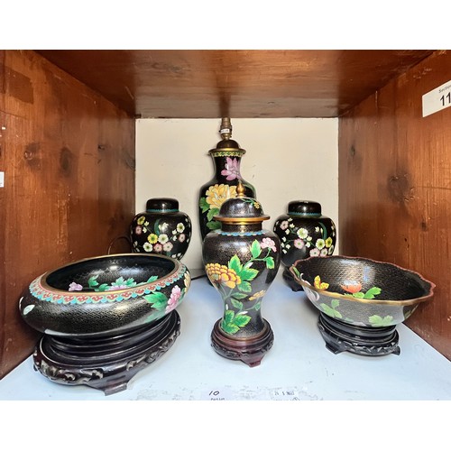 59 - A pair of black ground cloisonne ginger jars and covers on wooden stands, 21cm high, and a similar b... 