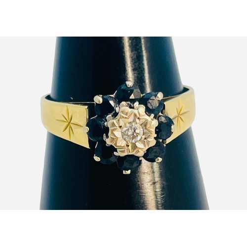 146 - An 18ct yellow gold dress ring, illusion set with a small round diamond to the centre, and eight fac... 