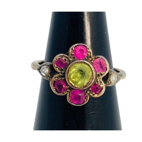 149 - A 15ct gold dress ring, in Suffragette coloured stones, a green faceted centre stone, surrounded by ... 