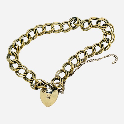 152 - A 9ct yellow gold double link curb bracelet, with heart padlock, weighs 12.1 grams.