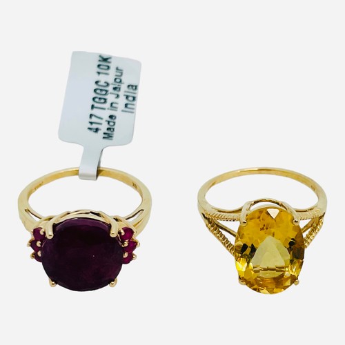 188 - A 9ct yellow gold dress ring, set with a round faceted garnet, with 3 x small garnets set to each sh... 